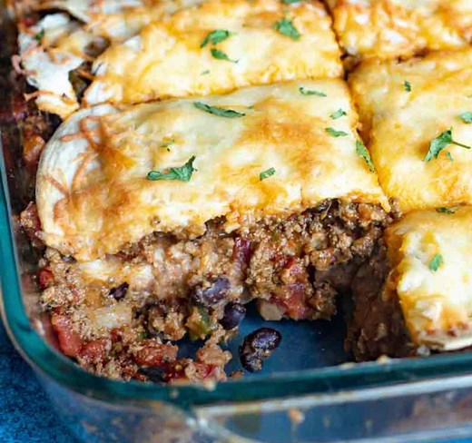 1.3M views · 11K reactions | A new way to serve up tacos…layered taco lasagna. This easy Mexican casserole is full of beef, beans, tomatoes and flour tortillas. https://www.tastesoflizzyt.com/taco-lasagna/ | Tastes of Lizzy T | Facebook