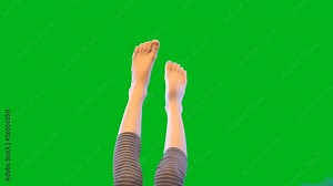 Baby feet on green background. Movement in the air. Bare feet. Light skin. Girl's body. Without a face. The video in 4K.