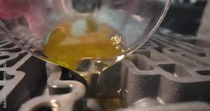 Scientist pouring engine oil into metal gearbox closeup 4k movie slow motion. Auto parts quality control concept