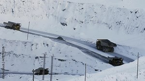 Industrial view of opencast mining quarry with lots of machinery at work. Extraction of gold, copper. Work of trucks in an open pit on gold mining