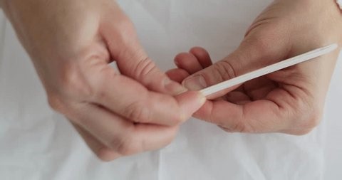 clip-4008149781-female-hands-holding-nail-file-giving-herself