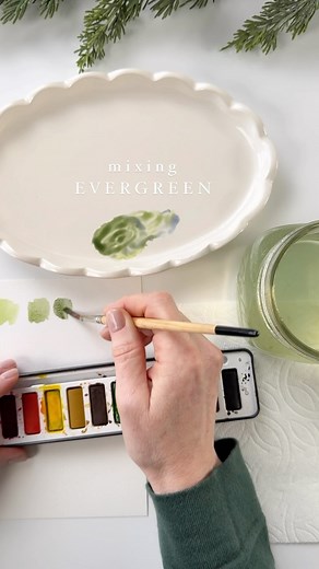 Emily Lex on Instagram: "Mixing evergreen 🌲 One of my favorite parts of painting with watercolor is mixing colors. You can get every imaginable color just by mixing basic colors together. Here’s how to mix a beautiful evergreen color: Start by waking up the paint with your brush full of water and transfer to a palette (any white dish will do!). The green from your paint set is pretty, but just a bit too bright for what we’re going for. So add a dab of the Payne’s gray and mix with the green. If