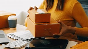 Entrepreneurial Success, Small Business Start Up, Witness the success story of a businesswoman starting her SME venture, managing online parcel delivery from the comfort of her home, showcasing