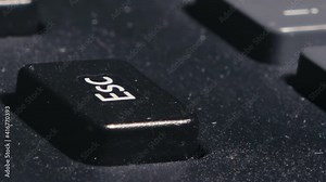 the finger presses the escape key several times. various pressing of the esc key. slow single and fast multiple taps.