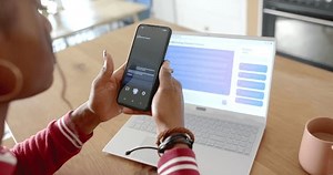 clip-3706655505-african-american-woman-holding-smartphone-showing-ai