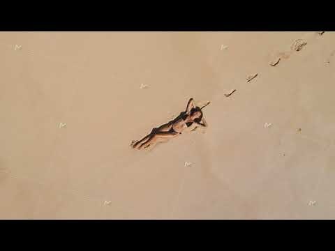 Top Aerial View of Woman in Swimsuit Bikini Relaxing and Sunbathing on Beach