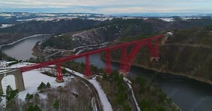 Aerial view winter landscape of Truyere river with Garabit Viaduct, French railway arched viaduct in Cantal department. Garabit Eiffel