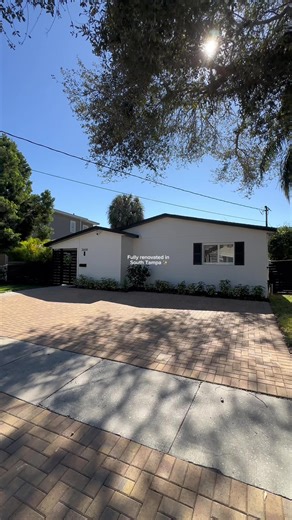 Fully Renovated & Move-In Ready 2BR | 2BA | Flood Zone X $899,000 Featuring an entertainer’s kitchen with an 11-ft quartz island, custom inset shaker cabinetry, Café stainless appliances (2025) built-in wine & beverage fridge. Hidden LG washer/dryer (2025)keeps the space sleek and functional. Major upgrades for peace of mind: new roof (2025), impact windows, exterior paint (2025), AC & water heater (2023). Smooth walls, LED lighting, wood-look LVT flooring, and fully remodeled baths (2025) eleva