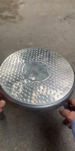 Low stainless steel stools are used in the kitchen for picking vegetables and preparing food.