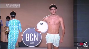 Exciting Indoor Fashion Show Featuring Male Swimwear
