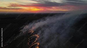 aerial view of a burning field. fire on a field in the plain, fire and smoke. sunset and fire in the field. care for the environment. air pollution