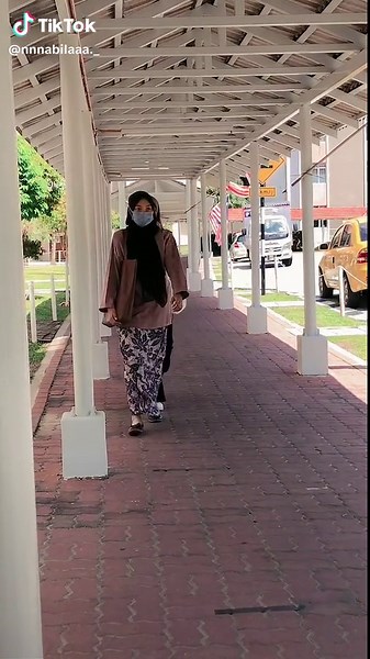Scenic Urban Walkway with Colorful Cars and Pillars