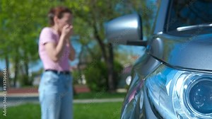 Angry lady driver stand by accident car. A view of depressed female look for somebody help by the wrecked modern car.