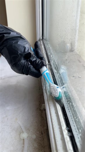 Deep Cleaning a Dirty Window with a Small Brush