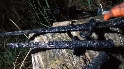 Weapons pulled from a wartime pond after dark