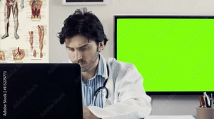 Doctor using computer in medical medical office, green screen