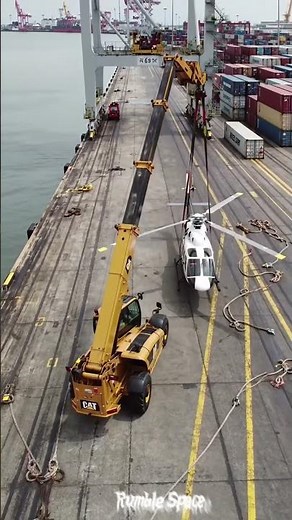 Look at this incredible heavy machine that lifts a helicopter with ease!