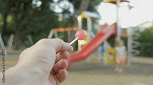 Children safety protection, kidnapping concept. Suspicious adult man spying on kids and calls a child to himself. First-person view. Stranger on the playground offers candy to child. Kids in danger.