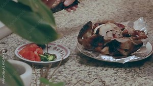 Pouring soysauce and squeezing calamansi lime to make sawsawan or dipping sauce paired with lechon manok or roasted chicken that is an authentic local Filipino food