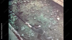 Parkour, young man jumping over fence, climbing building wall using rope in urban outdoor. Active skilled athlete man make extreme exercise. Professional sport trick. Vintage color film. Retro archive