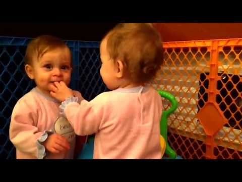 Identical twin baby girls learn how to give each other little kisses