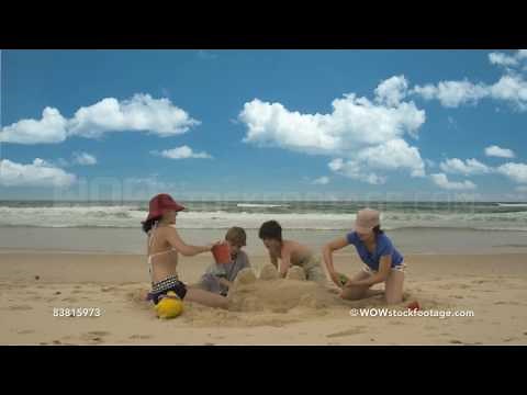 Time-lapse of four children building sand castle on beach, Byron Bay, New South Wales, Australia