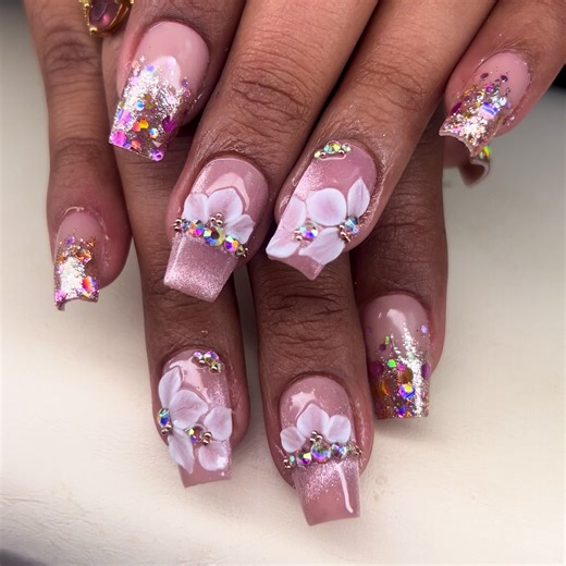 Soft glam acrylic full set featuring a nude pink base, iridescent glitter fade, hand-painted 3D florals, and AB crystal accents 💎 Elegant, feminine, and made to shine 📍 NM Studio Esthetics 📲 Bookings by appointment only 291-0103 🔗 Use booking link to check availability #NMStudioEsthetics #TrinidadNails #TTSmallBusiness #LuxuryNailsTT #AcrylicNailsTT CustomNails 3DNailArt FloralNails GlitterNails ABCrystalNails NudePinkNails FullSetAcrylic HandPaintedNails NailTechTT NailInspoTT SlayYourNails