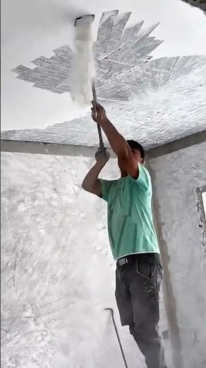 scraping and removing the old texture from a high ceiling using a long handled metal scraping tool