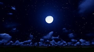 Full moon behind clouds at night