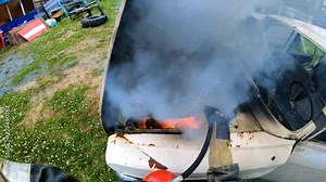 Firefighter extinguishes a burning car with a fire extinguisher.Carbon dioxide fire extinguisher.Fire on the transport.