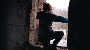 clip-1090290437-teenager-jacket-walks-through-dark-abandoned-house