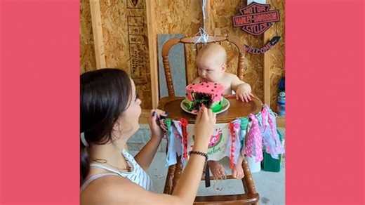Baby gives her best 'death stare' after big sister takes a bite of her cake