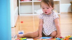 clip-12256034-happy-toddler-girl-enjoying-watching-her-tablet