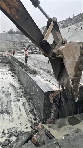 Machines are being used to move large stones.