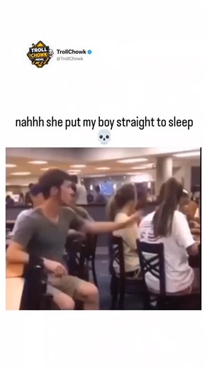 TrollChowk on Instagram: "This video captures a chaotic and humorous prank unfolding in what appears to be a busy school cafeteria or dining hall. The focus is on a young man in a grey T-shirt sitting at a table, surrounded by chatting students. Suddenly, amid the noise, a hand strikes him directly in the face with a massive cloud of white powder, creating an instant burst of dust. The impact is punctuated by a loud slap sound effect. Immediately following the hit, the man playfully feigns being