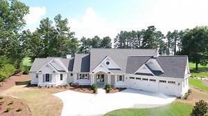 Check out Architectural Designs Country Craftsman House Plan 24374TW viewed from a drone. This home gives you 4 bedrooms - 2 on main and 2 upstairs - a vaulted interior across the entire center portion and an angled 3-car garage with bonus space above. Build it and you get over 3,000 square feet of heated living space to enjoy. Ready when you are. Where do YOU want to build? Plans: https://www.architecturaldesigns.com/24374TW | Architectural Designs - House Plans