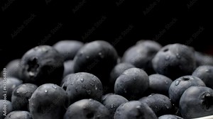 Drops of water on ripe sweet blueberries. fresh blueberries or dove spins. Vegan and vegetarian concept. Macrotexture of blueberries. Close-up texture of blueberries. Macro on black background
