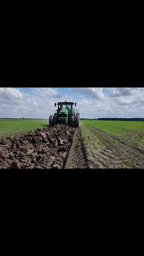 John Deere Tractor in Action: Plowing a Vast Field