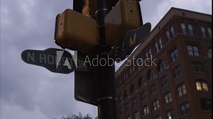 Dusk shot of the cross street sign N. Houston St. and Elm St. with the Texas School Book Depository in the background. Dealey Plaza, Dallas, Texas.