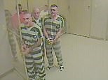 Inmates break free from holding cell to help armed guard