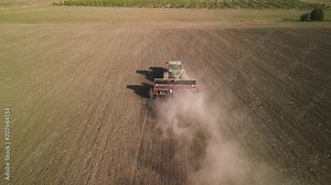 Tractor on the field seeding wheat