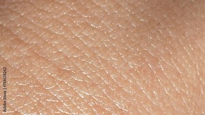 Camera's precision zoom unveils every pore, crease, and imperfection, showcasing diverse textures-smoothness contrasts ruggedness, revealing unique landscape. Skin care and Anti-aging concept. 4K UHD.