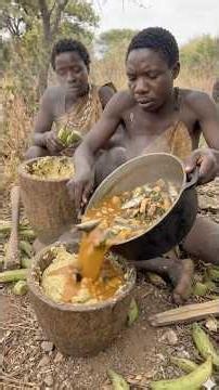 Hadzabe tribe bushman cooking fufu with delicious stew in the wild