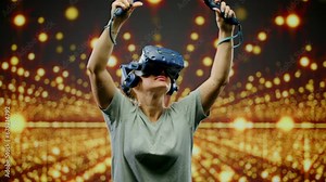 The woman wearing VR headset dancing in virtual reality. The beautiful woman in modern virtual reality dance game.Led screen with blur background in glow lights.Concept high technology digital device
