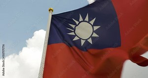 The Taiwanese flag waving in the wind. Sunny sky with clouds in Taipei City, Taiwan, Republic of China. National symbol and colors. Stock Video