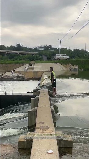 Worker Tapping Stuck Gate To Release Floodwater