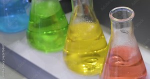 Liquid mixing in glass beaker for science experiment. Close up. Analytical laboratory. Mixing of the solution. Laboratory Mixer.