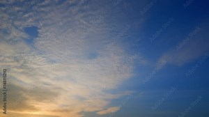 4K : Sunset sky time lapse : A timelapse, the sunset sky dances with vibrant hues. Wispy clouds paint strokes of gold, pink, and purple, creating a breathtaking masterpiece. Stock Video