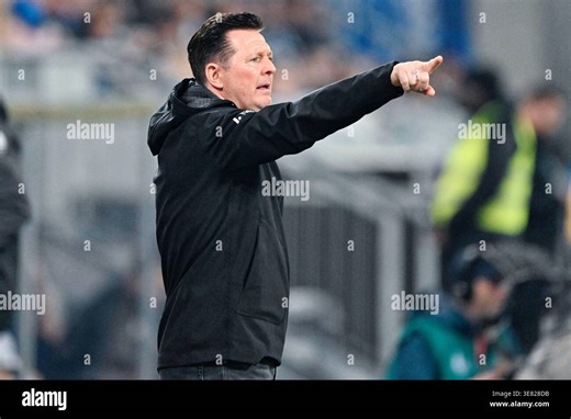 11 April 2026, Hesse, Darmstadt: Soccer, Men: Bundesliga 2, Darmstadt 98 - Hannover 96, Matchday 29, Merck-Stadion am Böllenfalltor. Coach Christian Titz (Hannover 96) gesticulates on the sidelines. Photo: Uwe Anspach/dpa - IMPORTANT NOTE: In accordance with the regulations of the DFL German Football League and the DFB German Football Association, it is prohibited to utilize or have utilized photographs taken in the stadium and/or of the match in the form of sequential images and/or video-like p