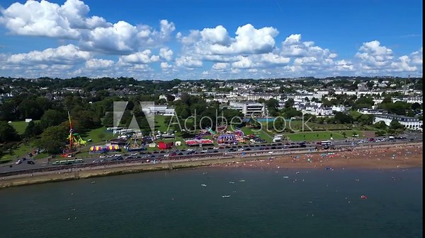 Torquay, Torbay, South Devon, England: DRONE VIEWS: Torre Abbey Sands beach; holidaymakers sunbathing and a funfair on Torre Abbey grounds. Torbay is a popular UK holiday resort (Clip 4 of 4).